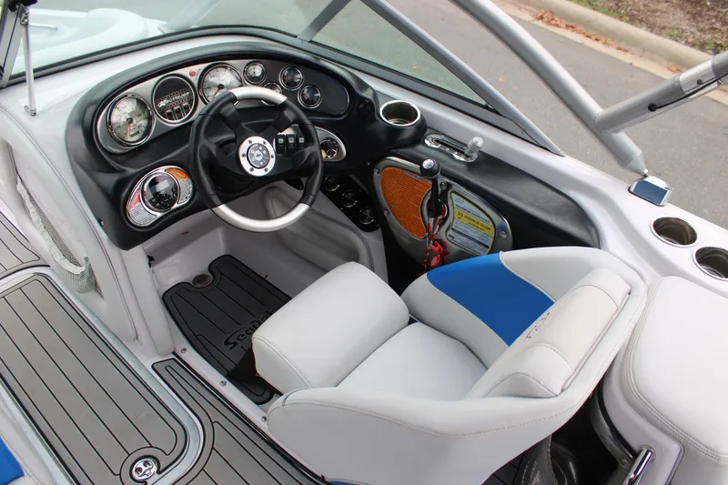 Slide: The Image of 2010 Correct Craft AIR NAUTIQUE SV 211 boat interior with steering wheel and dashboard controls. - 8