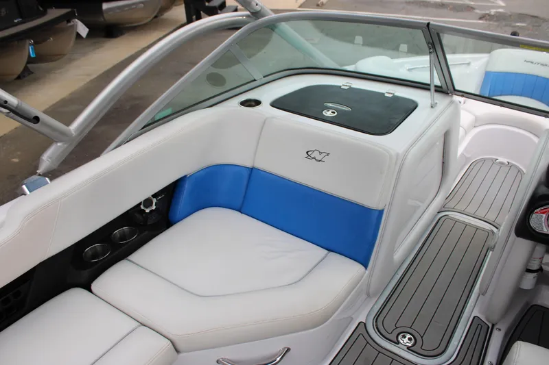 Slide: The Image of 2010 Correct Craft AIR NAUTIQUE SV 211 boat interior with blue and white seating. - 9