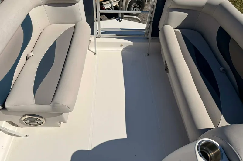 Slide: The Image of 2017 Hurricane FunDeck 196 OB interior with cushioned seating and cup holder. - 3