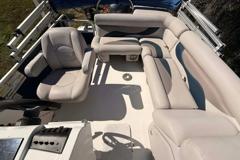 Slide: The Image of 2017 Hurricane FunDeck 196 OB interior with beige seating and steering console. - 4