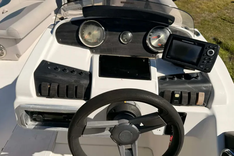 Slide: The Image of 2017 Hurricane FunDeck 196 OB boat dashboard with steering wheel and navigation controls. - 5