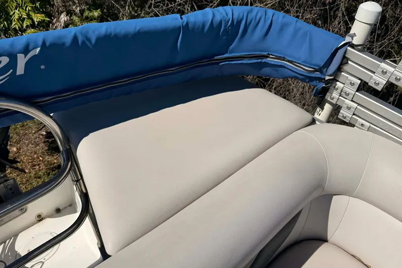 Slide: The Image of 2017 Hurricane FunDeck 196 OB boat with blue canopy and beige seating. - 7
