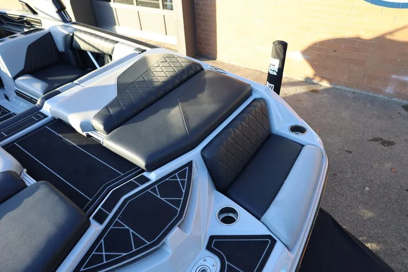 Slide: The Image of 2022 Tigé Z3 boat interior with black and gray seating, cup holders, and stylish design. - 13