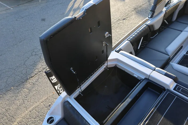 Slide: The Image of 2022 Tigé Z3 boat interior with open storage compartment and sleek seating design. - 18