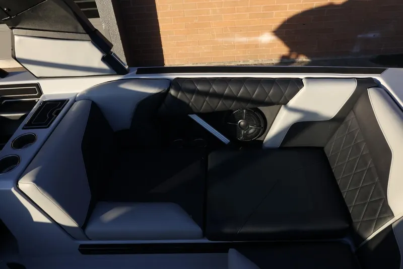 Slide: The Image of 2022 Tigé Z3 boat interior with black and white seating and cup holders. - 29