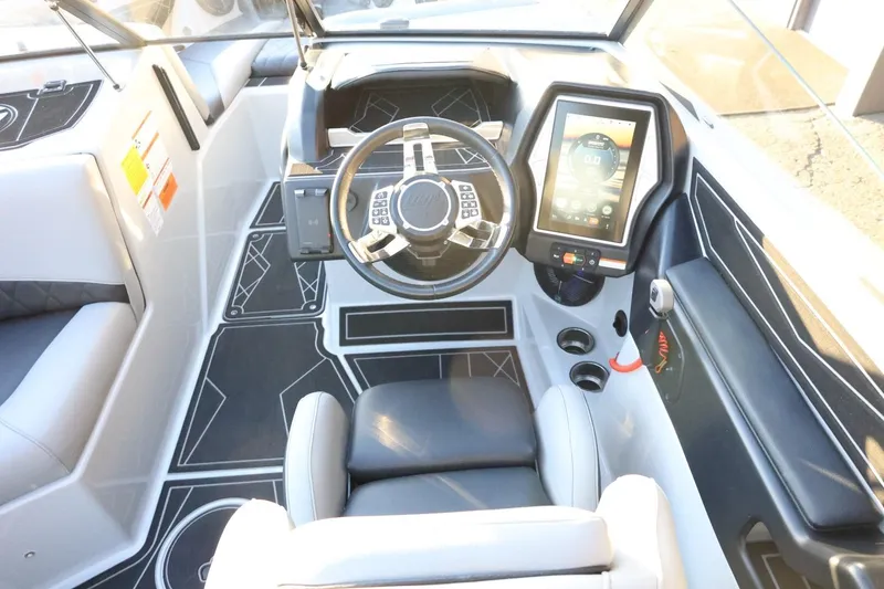 Slide: The Image of 2022 Tigé Z3 boat cockpit with modern steering and touchscreen controls. - 32