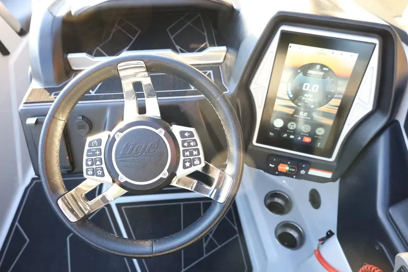 Slide: The Image of 2022 Tigé Z3 boat dashboard with steering wheel and touchscreen display. - 33