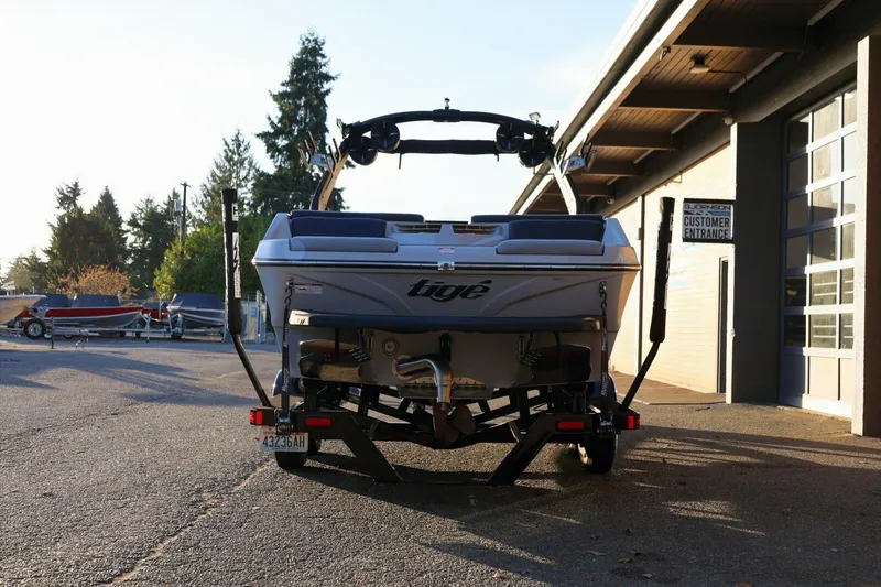 Slide: The Image of 2022 Tigé Z3 boat on trailer, parked outside a building in sunlight. - 4