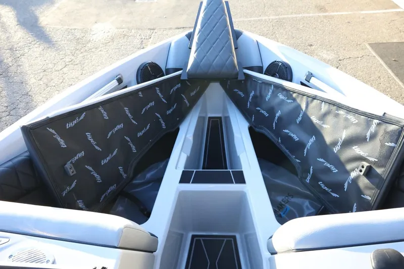 Slide: The Image of 2022 Tigé Z3 boat interior with open storage compartments and branded covers. - 47