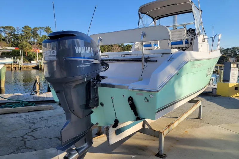 Slide: The Image of 2008 Cobia 236 Walk Around boat with Yamaha 250 engine at dockside. - 2