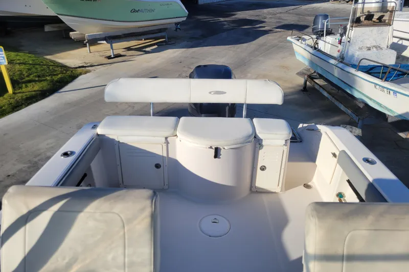Slide: The Image of 2008 Cobia 236 Walk Around boat interior with seating and storage compartments. - 6