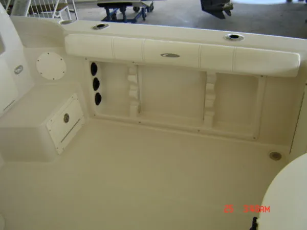 Slide: The Image of 2008 Cobia 236 Walk Around boat interior with storage compartments and seating. - 7