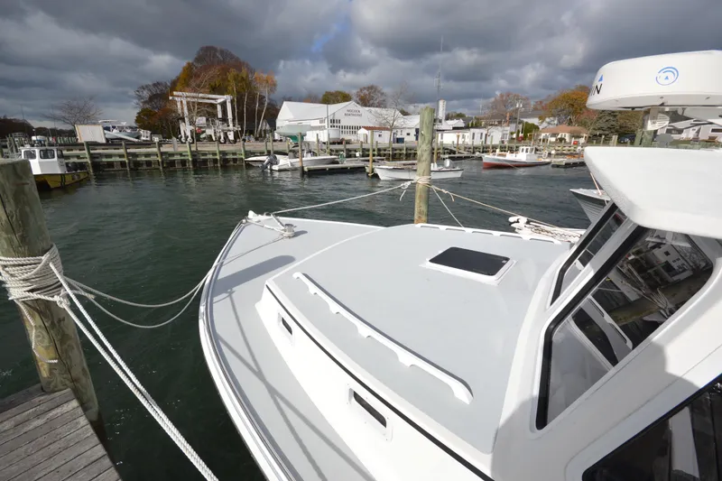 Slide: The Image of 2008 Wayne Beal EXPRESS boat docked at a marina under cloudy skies. - 10