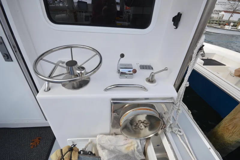 Slide: The Image of Control panel of a 2008 Wayne Beal EXPRESS boat with steering wheel and winch. - 13