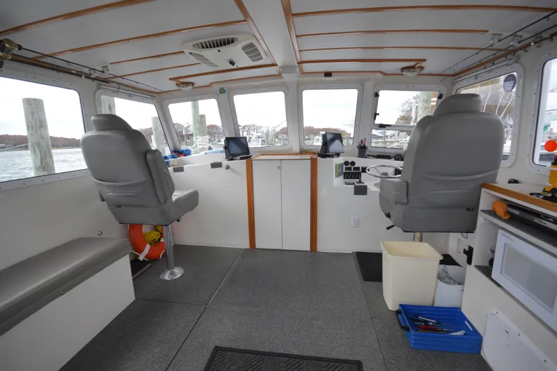 Slide: The Image of Interior of a 2008 Wayne Beal EXPRESS boat with helm and seating area. - 19