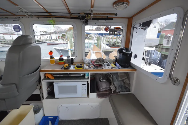 Slide: The Image of Interior of 2008 Wayne Beal EXPRESS boat with fishing gear and microwave. - 20