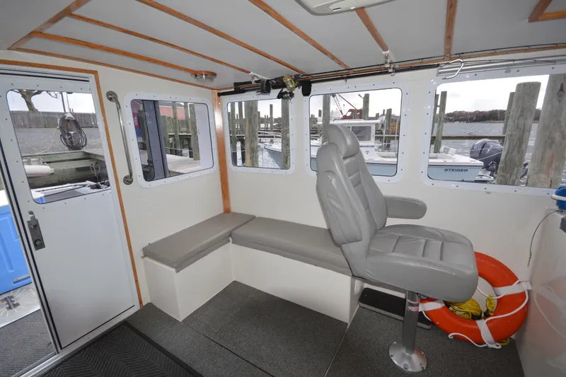 Slide: The Image of Interior of 2008 Wayne Beal EXPRESS boat with seating and windows overlooking dock. - 22