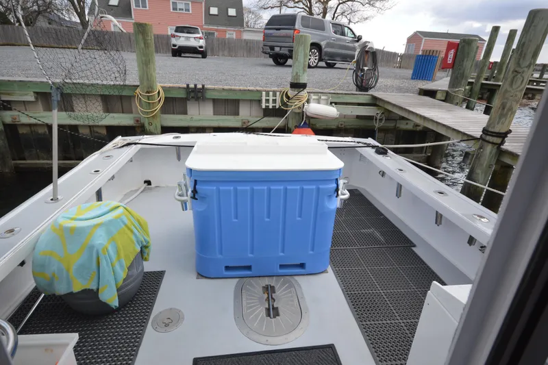 Slide: The Image of 2008 Wayne Beal EXPRESS boat deck with blue cooler and docked at marina. - 23