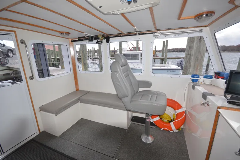 Slide: The Image of Interior of 2008 Wayne Beal EXPRESS boat with seating and life preserver. - 26