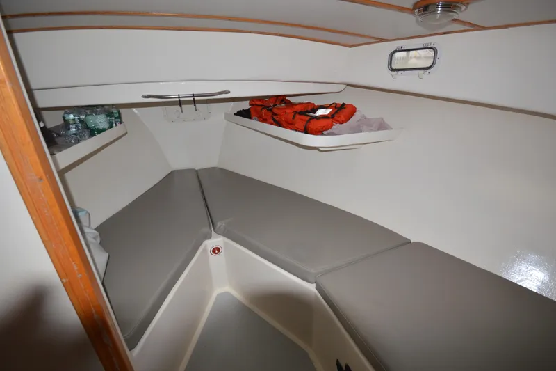 Slide: The Image of 2008 Wayne Beal EXPRESS boat interior with cushions, life jackets, and water bottles. - 32