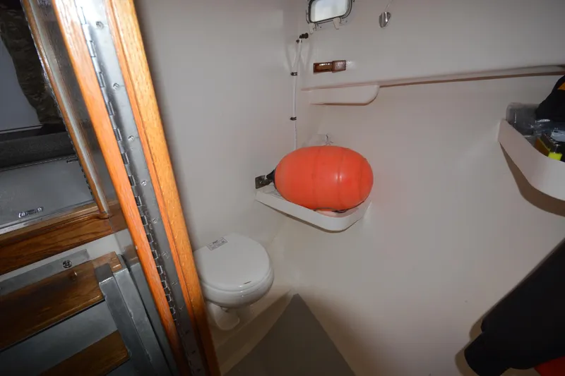 Slide: The Image of 2008 Wayne Beal EXPRESS boat interior with toilet and orange buoy. - 33