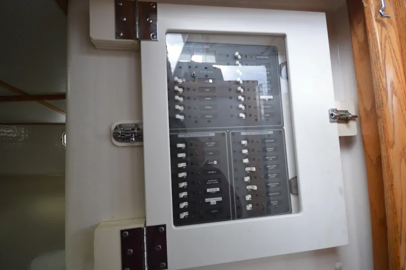 Slide: The Image of Electrical panel inside a 2008 Wayne Beal EXPRESS boat, featuring switches and circuit breakers. - 37