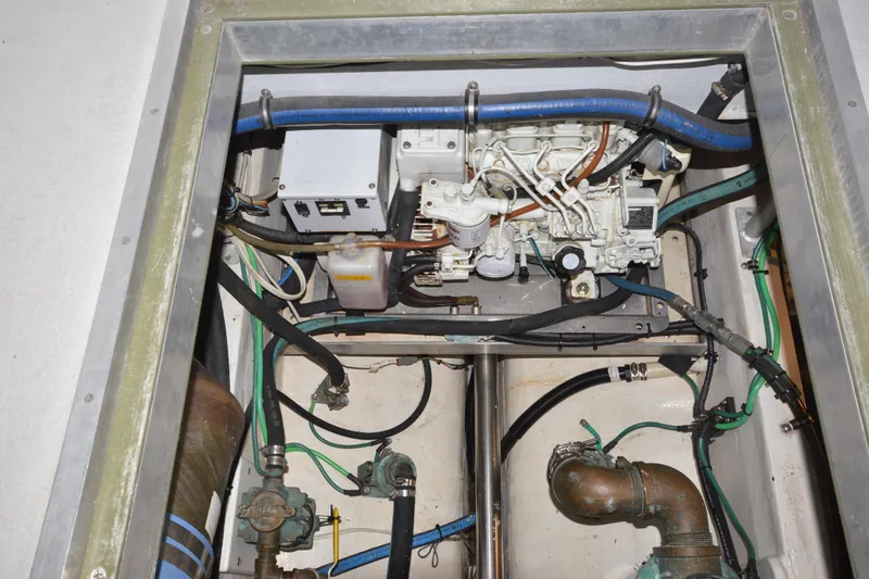 Slide: The Image of Engine compartment of a 2008 Wayne Beal EXPRESS boat, showcasing mechanical components and wiring. - 48