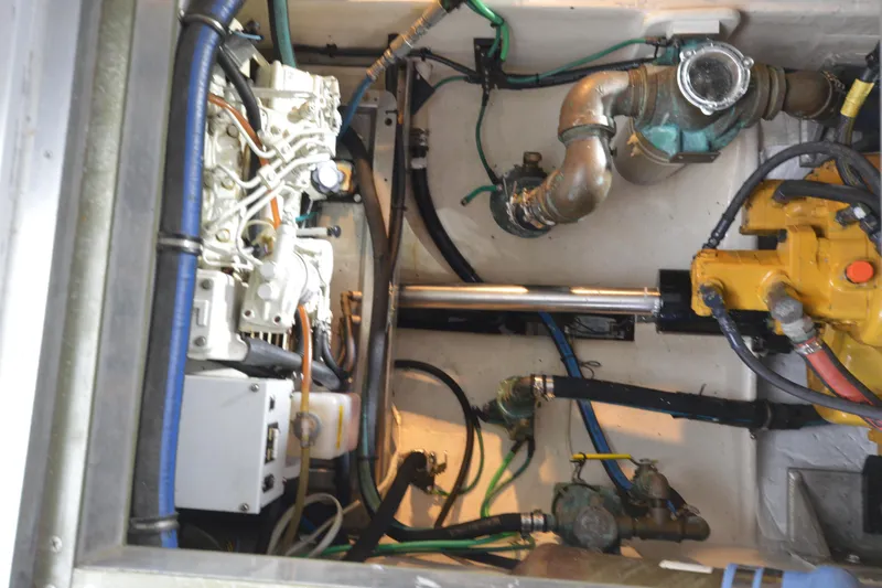 Slide: The Image of Engine compartment of a 2008 Wayne Beal EXPRESS boat, showcasing mechanical components and piping. - 49