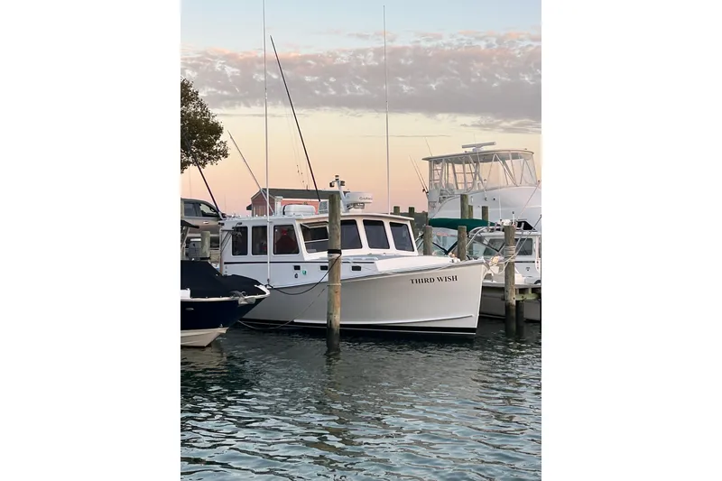 Slide: The Image of 2008 Wayne Beal EXPRESS boat named "Third Wish" docked at sunset. - 5