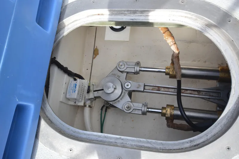 Slide: The Image of Hydraulic steering mechanism in 2008 Wayne Beal EXPRESS boat, featuring metal rods and cables. - 50