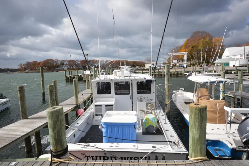 Slide: The Image of 2008 Wayne Beal EXPRESS boat docked at a marina under cloudy skies. - 6