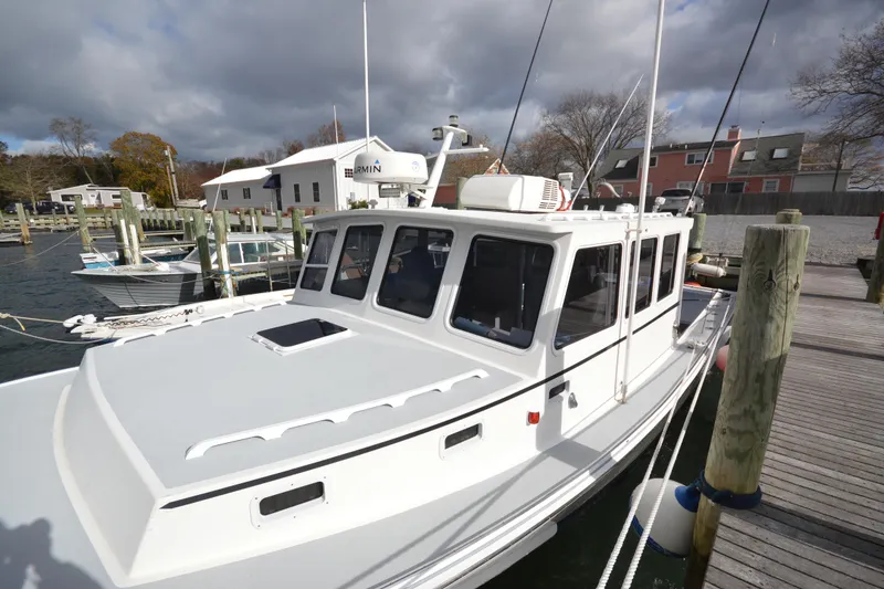 Slide: The Image of 2008 Wayne Beal EXPRESS boat docked at a marina under cloudy skies. - 9