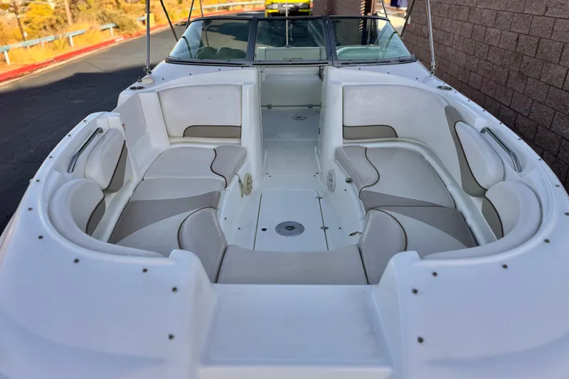 Slide: The Image of 2004 Glastron DX 235 Deckboat with spacious seating and sleek design. - 12