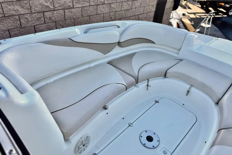 Slide: The Image of 2004 Glastron DX 235 Deckboat interior with white cushioned seating. - 14