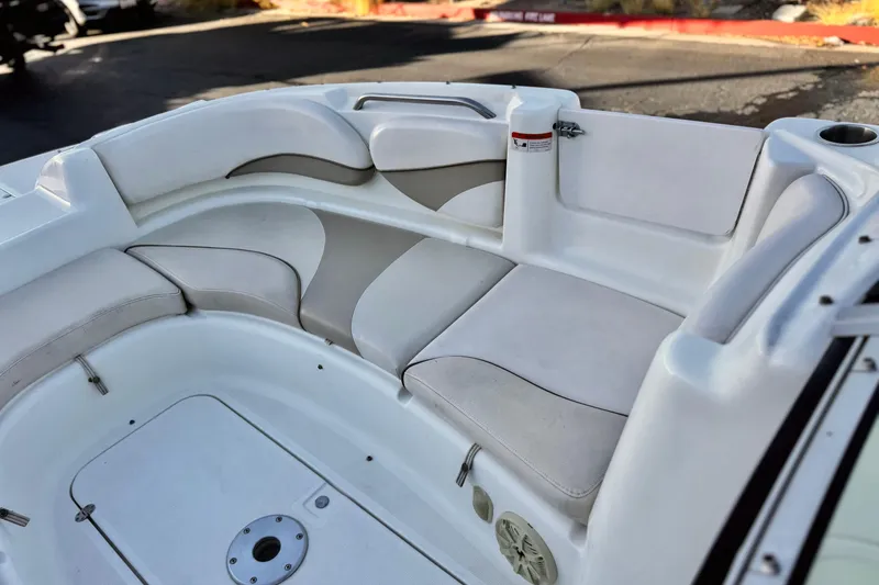 Slide: The Image of 2004 Glastron DX 235 Deckboat interior with white and beige seating. - 15