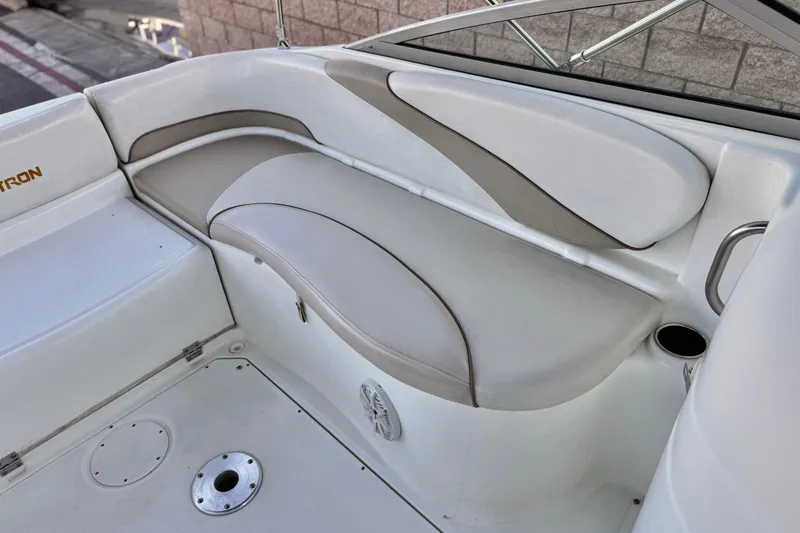 Slide: The Image of 2004 Glastron DX 235 Deckboat interior seating with beige and white upholstery. - 20