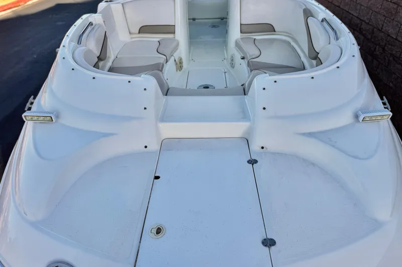 Slide: The Image of 2004 Glastron DX 235 Deckboat with spacious seating and sleek white design. - 8