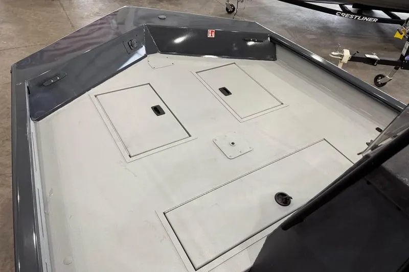 Slide: The Image of 2026 Crestliner 1870 Retriever FCC boat interior with steering console and storage compartments. - 15