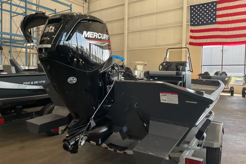 Slide: The Image of 2026 Crestliner 1870 Retriever FCC boat displayed in a spacious indoor showroom. - 3