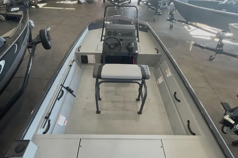 Slide: The Image of 2026 Crestliner 1870 Retriever FCC boat displayed in a showroom with other boats. - 5