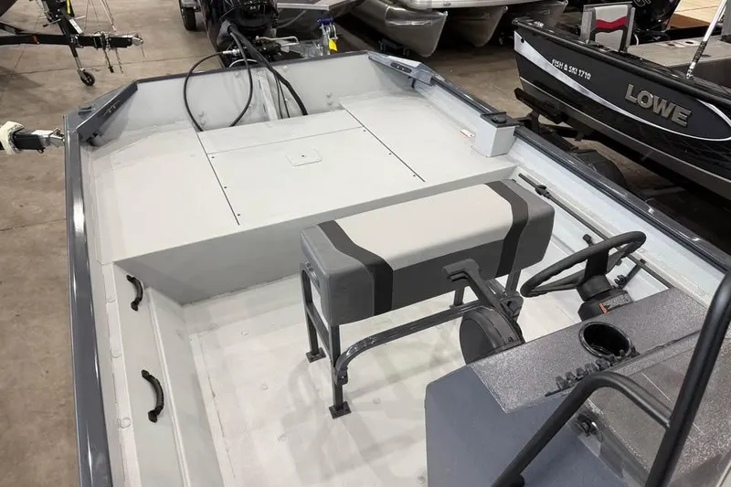 Slide: The Image of 2026 Crestliner 1870 Retriever FCC boat with Mercury engine in showroom, American flag displayed. - 7