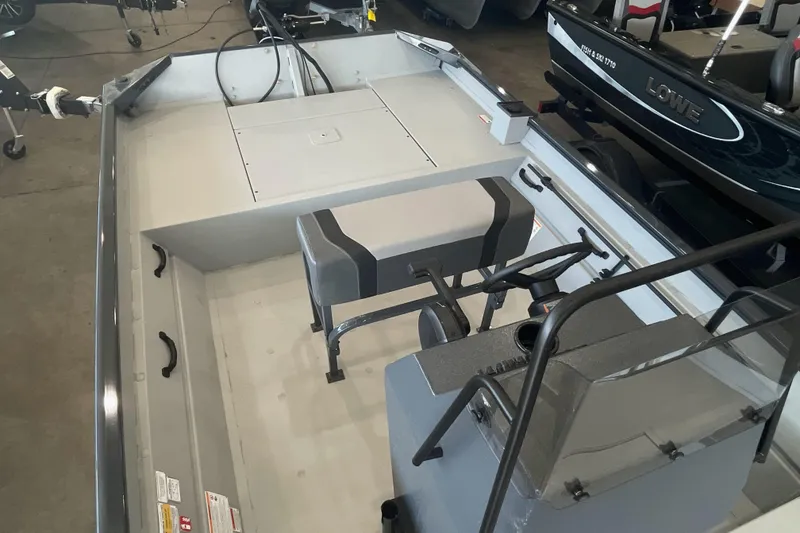 Slide: The Image of 2026 Crestliner 1870 Retriever FCC boat in showroom with American flag backdrop. - 9