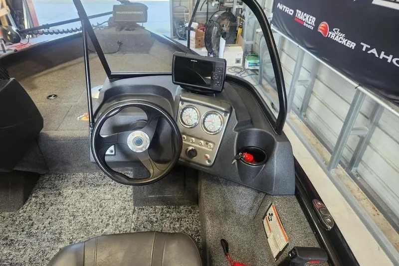 Slide: The Image of 2025 Tracker Pro Guide V-16 WT boat interior with steering wheel and dashboard controls. - 7