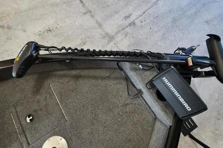 Slide: The Image of 2025 Tracker Pro Guide V-16 WT boat with Humminbird trolling motor on deck. - 9