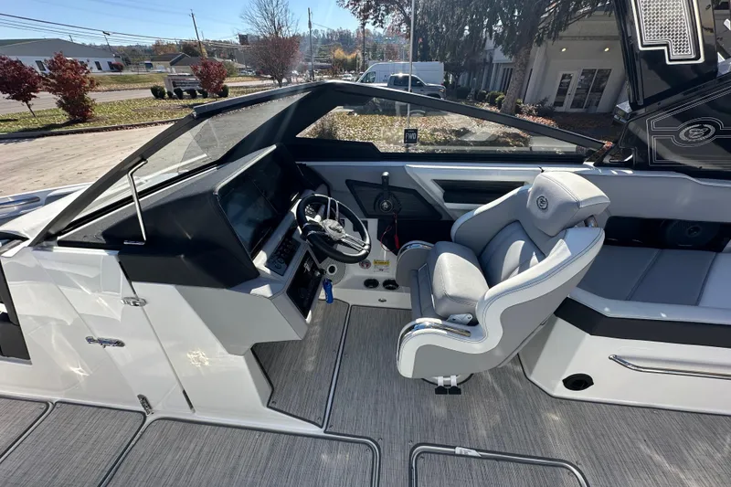 Slide: The Image of 2023 Cobalt R6 Surf boat interior with modern helm and comfortable seating. - 12