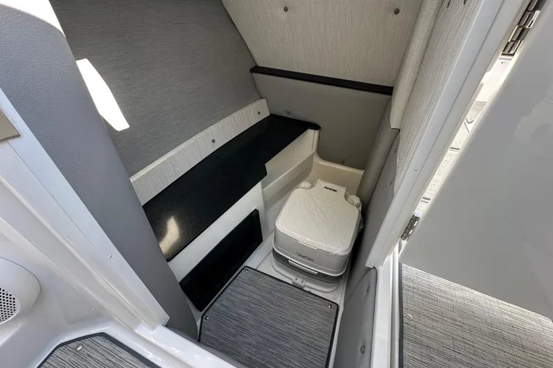Slide: The Image of 2023 Cobalt R6 Surf boat interior with compact toilet and modern design. - 17