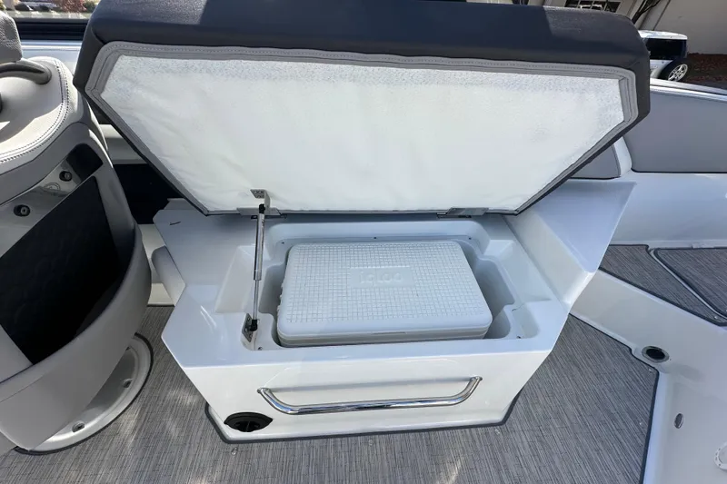 Slide: The Image of 2023 Cobalt R6 Surf boat with open storage compartment and cooler. - 18
