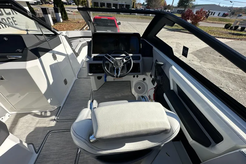 Slide: The Image of 2023 Cobalt R6 Surf boat interior with steering wheel and dashboard controls. - 8