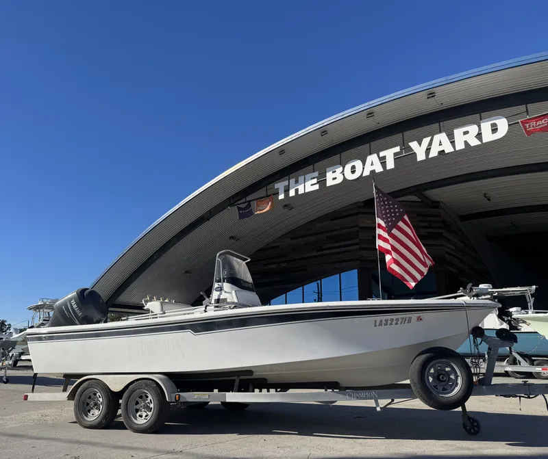 Slide: The Image of 2007 Champion 22 Bay boat on trailer at The Boat Yard, with American flag. - 17