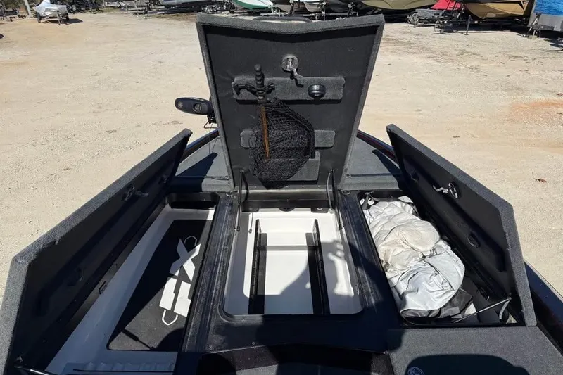 Slide: The Image of 2018 Skeeter FX21 Limited Edition boat storage compartments open, showing interior organization. - 16